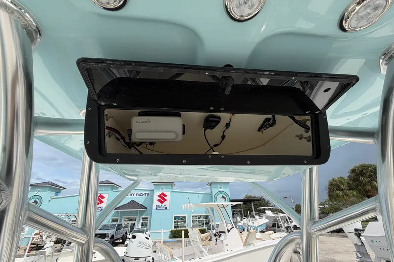 Slide: The Image of 2027 Pioneer 202 Sportfish boat electronics compartment with Garmin device, viewed from below. - 7