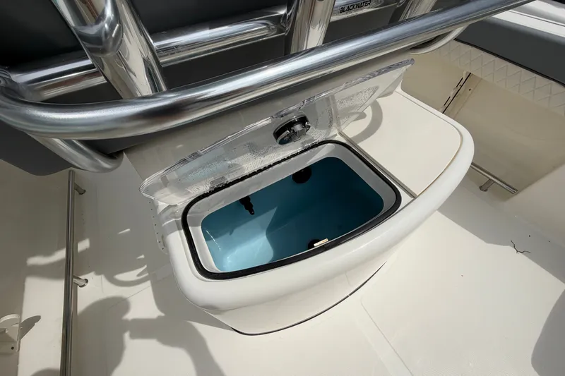 Slide: The Image of 2027 Pioneer 202 Sportfish boat livewell with open lid, showcasing interior details. - 14