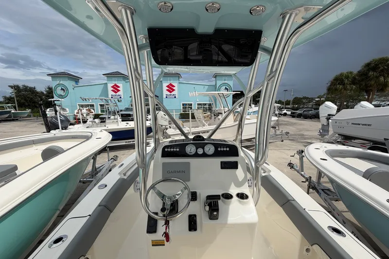 Slide: The Image of 2027 Pioneer 202 Sportfish boat interior with Garmin navigation, displayed at a dealership. - 5
