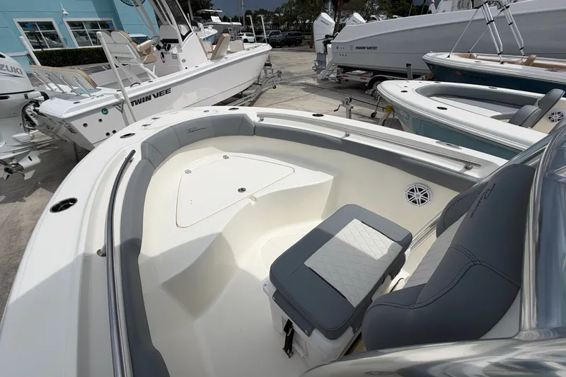 Slide: The Image of 2027 Pioneer 202 Sportfish boat interior with seating and storage, displayed outdoors. - 8