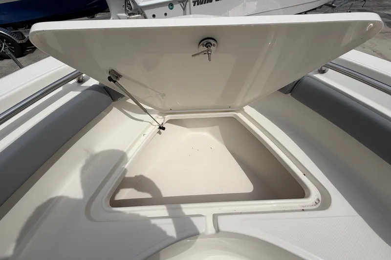 Slide: The Image of Open storage compartment on a 2027 Pioneer 202 Sportfish boat, showcasing spacious interior. - 9