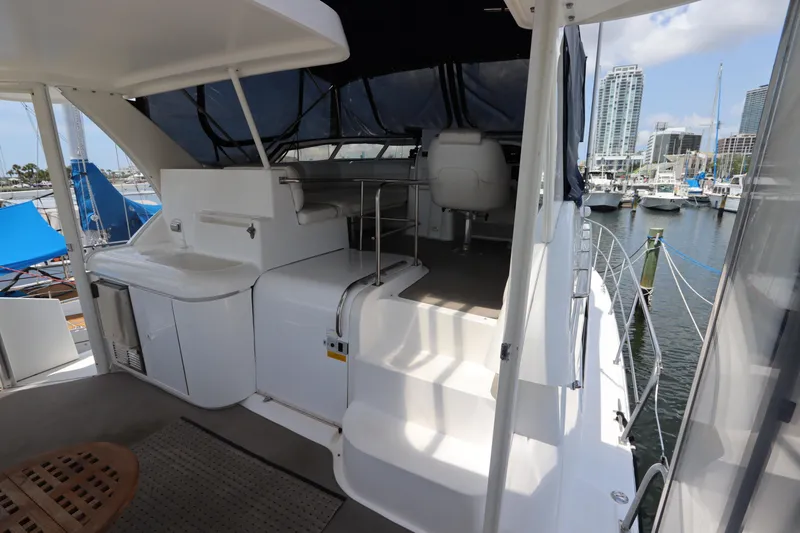 Slide: The Image of 1999 Cruisers Yachts 3750 Motoryacht interior with marina view, featuring seating and helm station. - 17