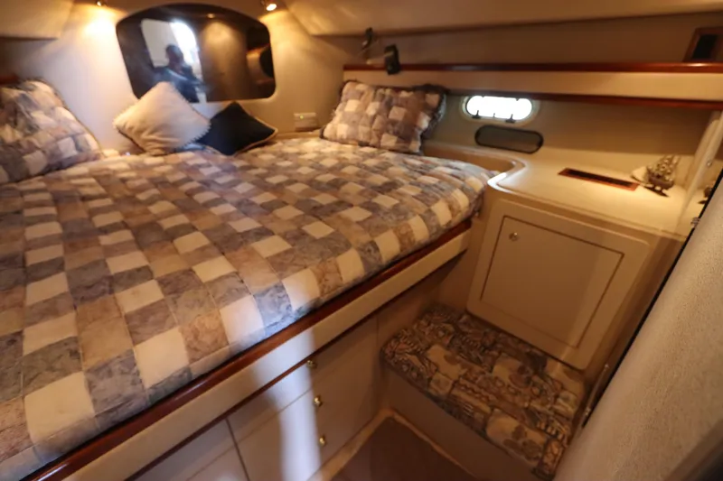 Slide: The Image of 1999 Cruisers Yachts 3750 Motoryacht cabin with cozy bed and storage. - 40