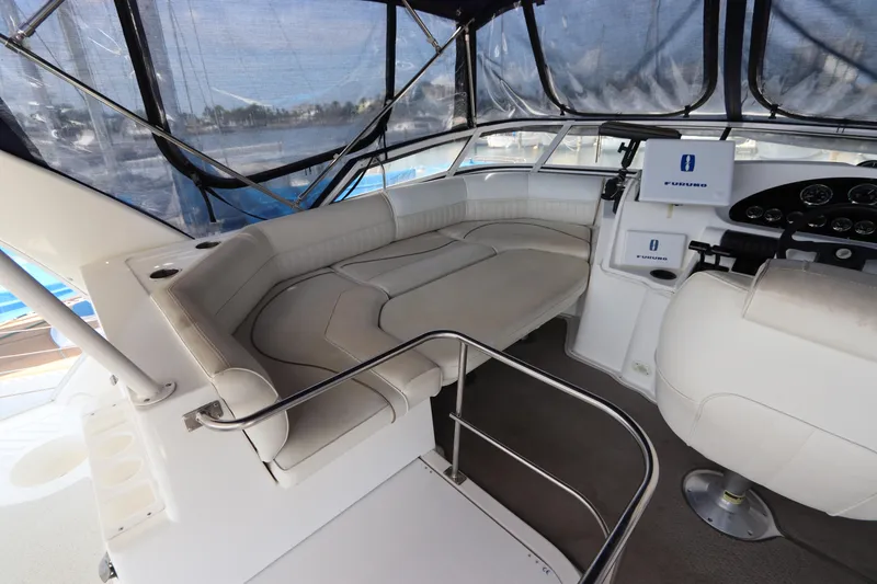 Slide: The Image of 1999 Cruisers Yachts 3750 Motoryacht interior with seating and helm, featuring modern navigation equipment. - 18