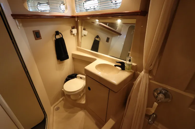 Slide: The Image of 1999 Cruisers Yachts 3750 Motoryacht bathroom with sink, toilet, and mirror. - 47