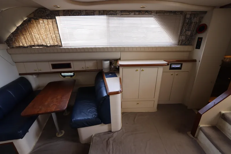 Slide: The Image of Interior of 1999 Cruisers Yachts 3750 Motoryacht with dining area and cabinetry. - 26