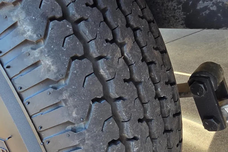 Slide: The Image of Close-up of a 2025 Ranger ALPHA 208 tire with rugged tread pattern. - 41