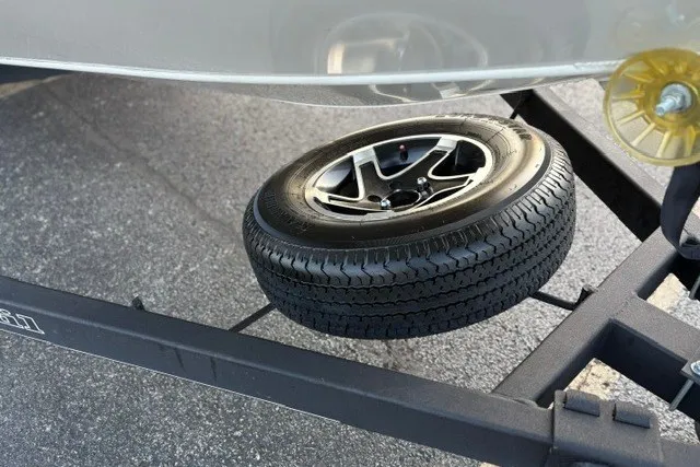 Slide: The Image of Spare tire mounted on a Ranger ALPHA 208 trailer, 2025 model, on asphalt surface. - 56