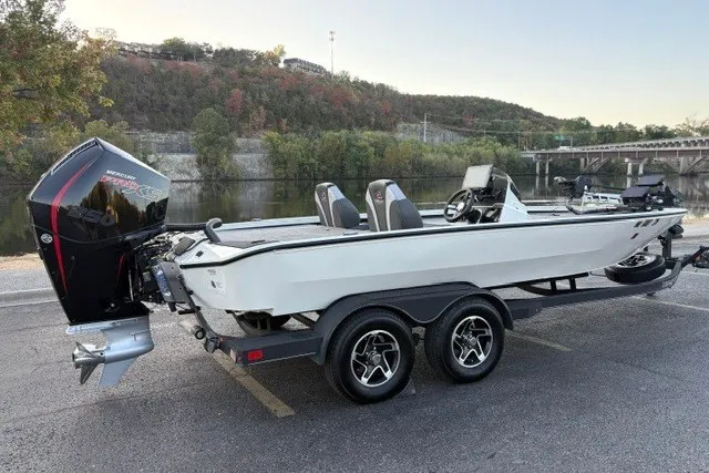 Slide: The Image of 2025 Ranger ALPHA 208 boat on trailer by riverside, featuring sleek design and powerful engine. - 6
