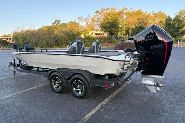 Slide: The Image of 2025 Ranger ALPHA 208 boat on trailer with powerful outboard motor in parking lot. - 5