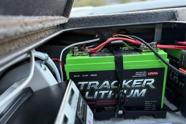 Slide: The Image of Green Tracker Lithium battery in Ranger ALPHA 208, 2025 model, secured with cables. - 70