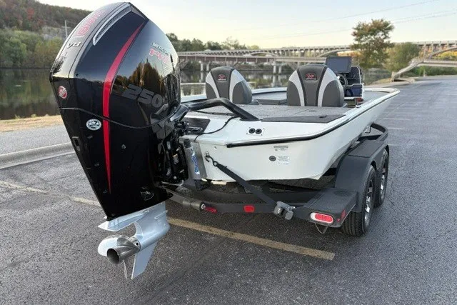 Slide: The Image of 2025 Ranger ALPHA 208 boat with powerful outboard motor, parked near a scenic river. - 12
