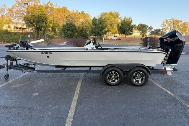 Slide: The Image of 2025 Ranger ALPHA 208 boat on trailer in parking lot, side view. - 2