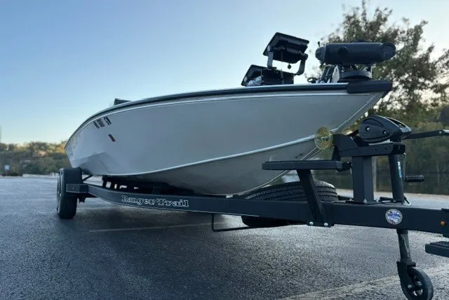 Slide: The Image of 2025 Ranger ALPHA 208 boat on trailer, sleek design, parked outdoors. - 8