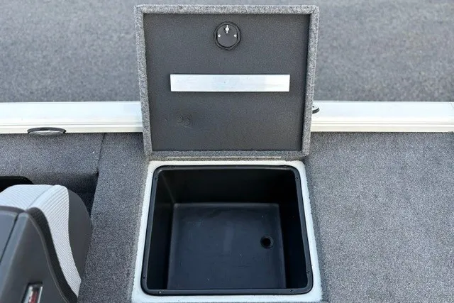 Slide: The Image of Open storage compartment in 2025 Ranger ALPHA 208 boat, featuring carpeted interior. - 43