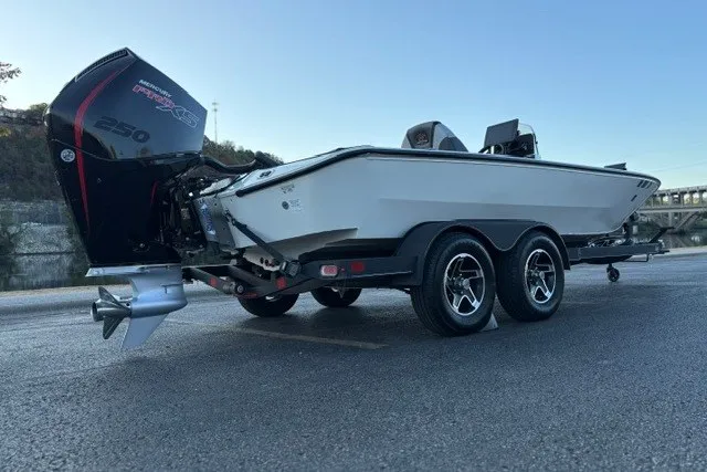 Slide: The Image of 2025 Ranger ALPHA 208 boat on trailer with powerful outboard motor. - 7