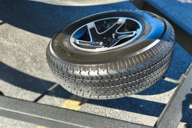 Slide: The Image of 2025 Ranger ALPHA 208 tire on a vehicle trailer, showcasing tread and alloy wheel design. - 32