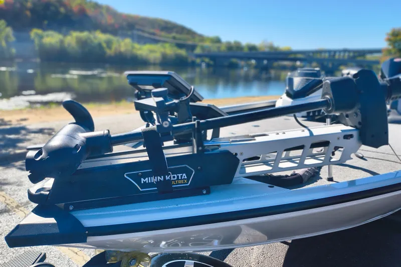 Slide: The Image of Ranger ALPHA 208 boat with Minn Kota Ultrex motor by a scenic river, 2025 model. - 18