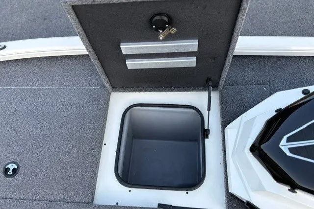 Slide: The Image of Open storage compartment in 2025 Ranger ALPHA 208 boat, featuring a secure lock mechanism. - 63