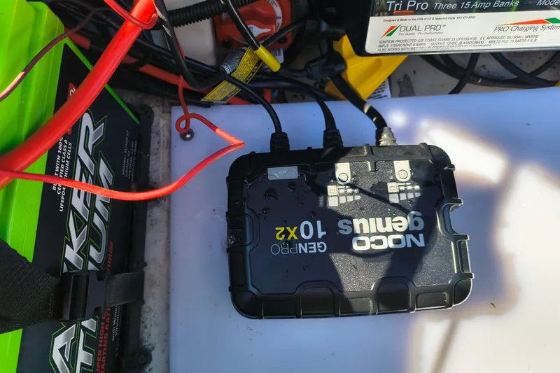 Slide: The Image of NOCO Genius 10X2 charger connected to a battery in a Ranger ALPHA 208, 2025 model. - 27