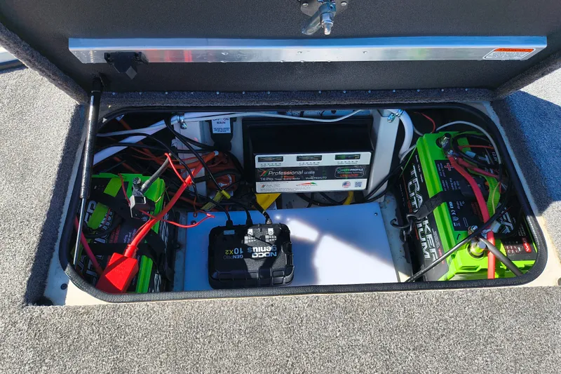 Slide: The Image of Electrical compartment of 2025 Ranger ALPHA 208 with batteries and wiring setup. - 25