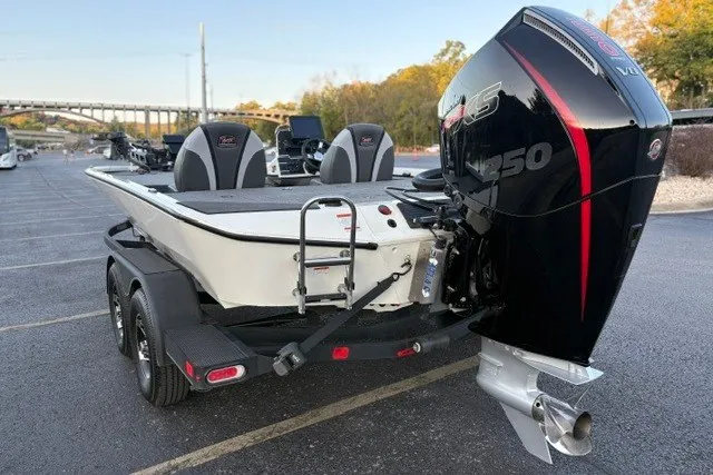 Slide: The Image of 2025 Ranger ALPHA 208 boat with powerful engine, parked on a trailer in a lot. - 10