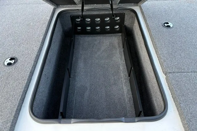 Slide: The Image of Open storage compartment in 2025 Ranger ALPHA 208 boat, featuring carpeted interior and secure latch. - 41