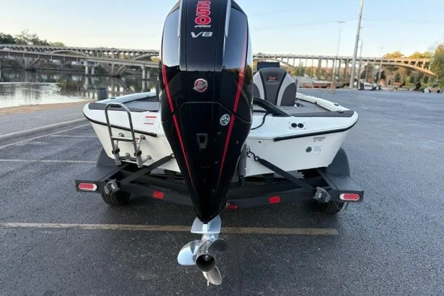 Slide: The Image of Ranger ALPHA 208 boat, 2025 model, with powerful V8 engine, parked near a scenic waterfront. - 11