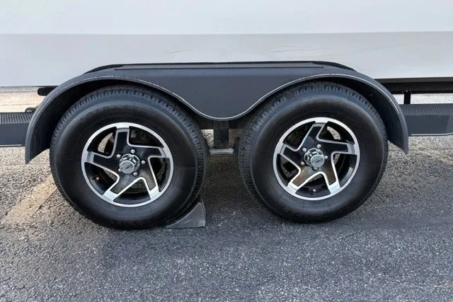 Slide: The Image of Trailer wheels of a 2025 Ranger ALPHA 208 on asphalt pavement. - 80