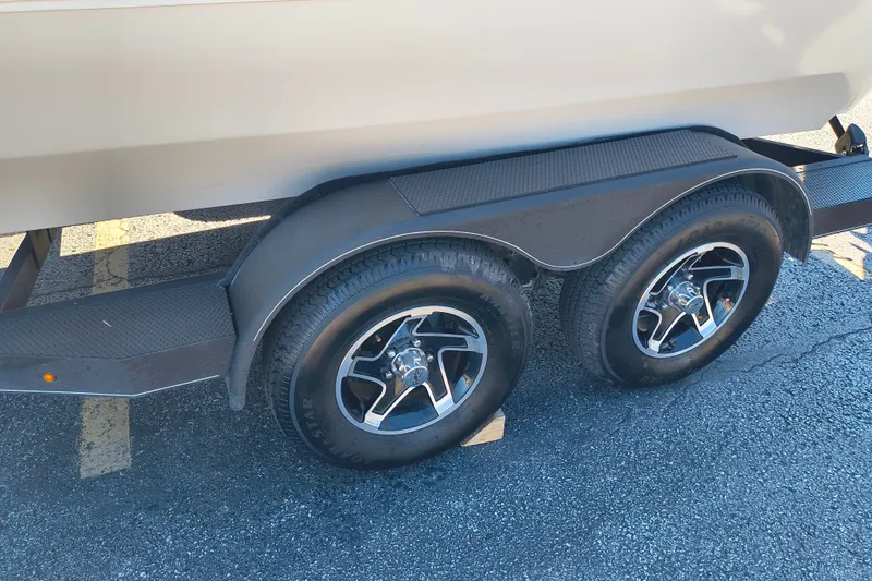 Slide: The Image of Trailer wheels of a 2025 Ranger ALPHA 208 on asphalt surface. - 35