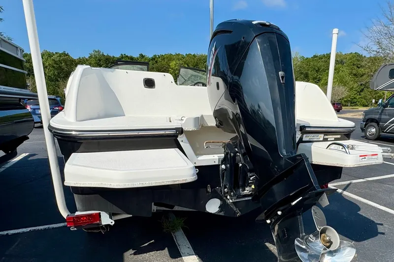 Slide: The Image of 2020 Bayliner Element E21 boat with outboard motor in a parking lot. - 3