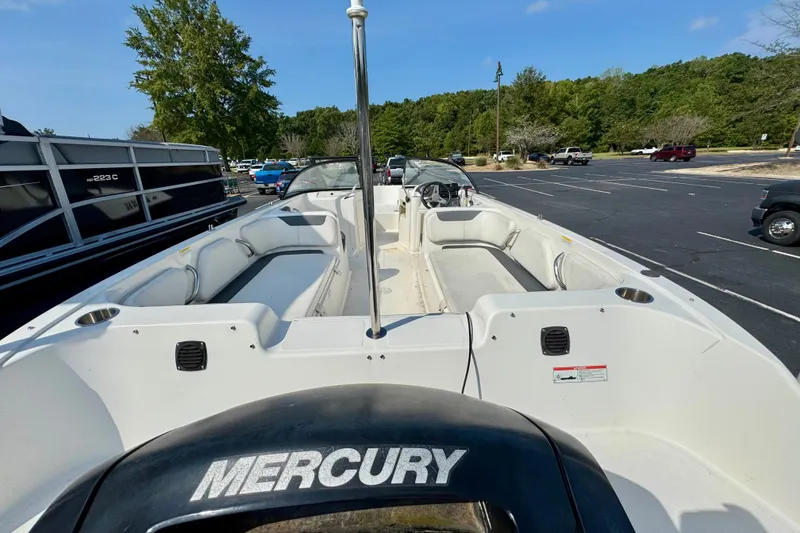 Slide: The Image of 2020 Bayliner Element E21 boat with Mercury engine in parking lot. - 2