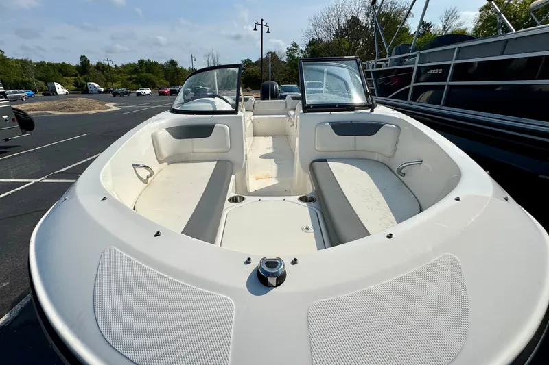 Slide: The Image of 2020 Bayliner Element E21 boat with spacious seating, parked outdoors. - 1