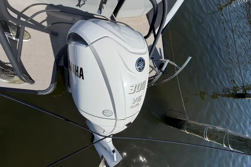 Slide: The Image of 2023 Godfrey AquaPatio 255 ULC with Yamaha 300 V6 outboard motor on water. - 21