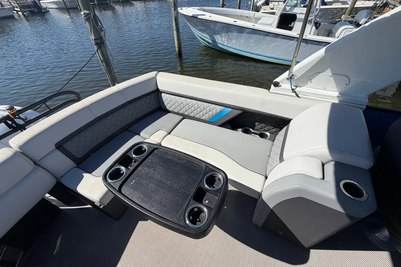 Slide: The Image of Luxurious seating area on 2023 Godfrey AquaPatio 255 ULC pontoon boat at marina. - 17