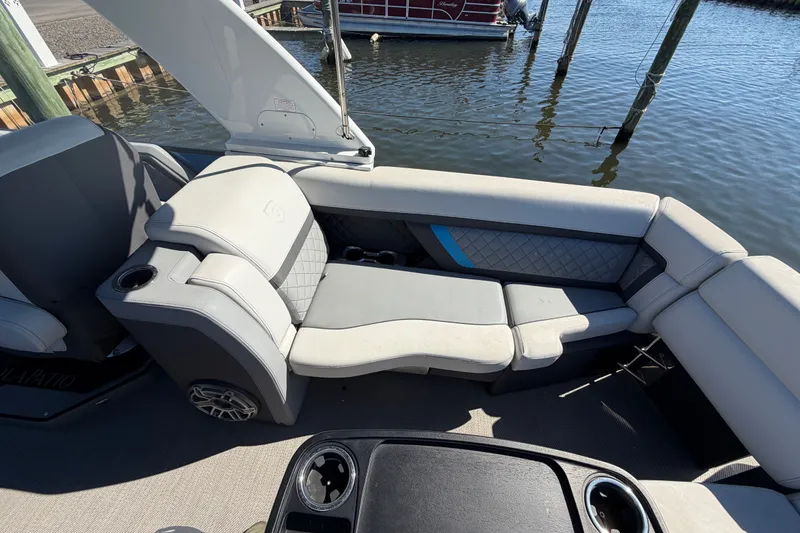 Slide: The Image of 2023 Godfrey AquaPatio 255 ULC boat interior with luxurious seating and cup holders. - 14