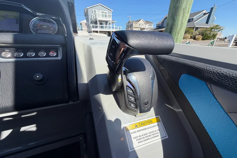 Slide: The Image of Control panel of 2023 Godfrey AquaPatio 255 ULC boat with throttle and caution label. - 24