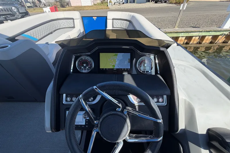 Slide: The Image of Cockpit view of 2023 Godfrey AquaPatio 255 ULC boat with modern dashboard and steering wheel. - 23