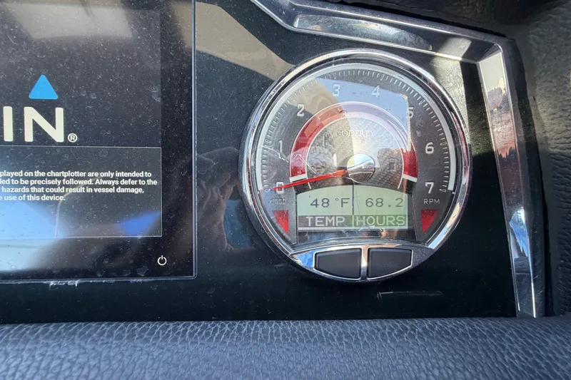 Slide: The Image of Dashboard of 2023 Godfrey AquaPatio 255 ULC showing temperature and RPM gauge. - 22