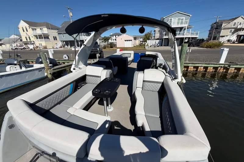 Slide: The Image of 2023 Godfrey AquaPatio 255 ULC pontoon boat docked, featuring spacious seating and modern design. - 18