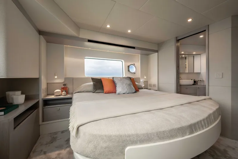 Slide: The Image of Luxurious cabin of the 2028 Absolute Navetta 50 with a large bed and modern bathroom. - 12