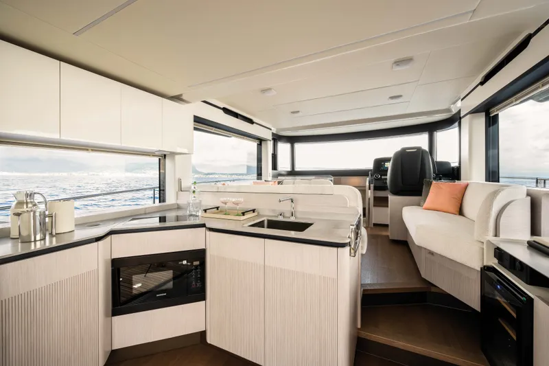 Slide: The Image of The interior of the 2028 Absolute Navetta 50 features a modern kitchen and seating area. - 7
