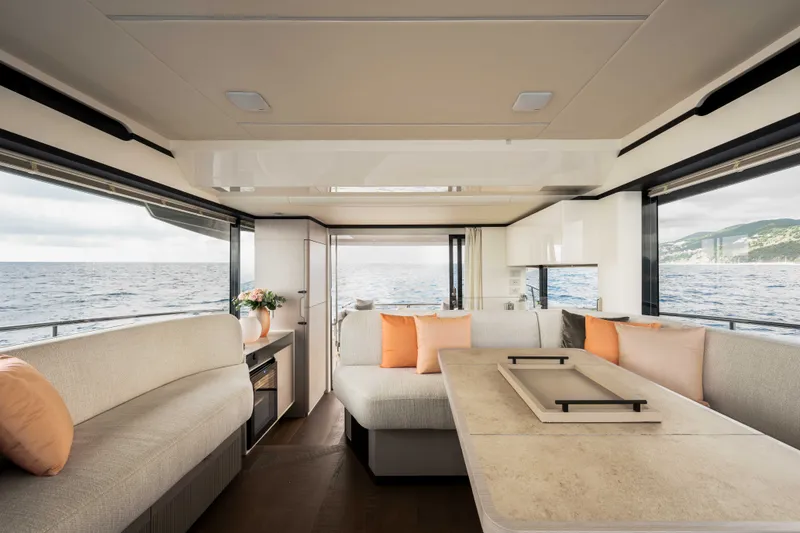 Slide: The Image of The interior of the 2028 Absolute Navetta 50 features elegant, modern design with large windows. - 8