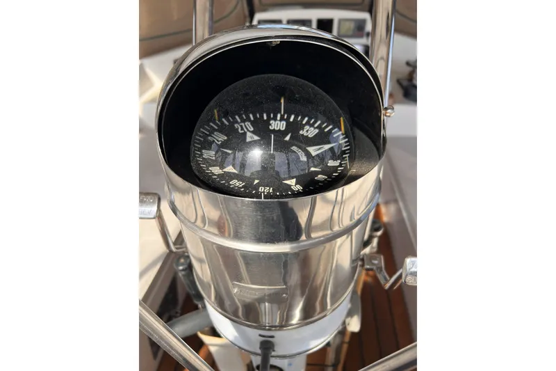 Slide: The Image of Close-up of a compass on a 1991 Perry 51 yacht, showing navigation details. - 38