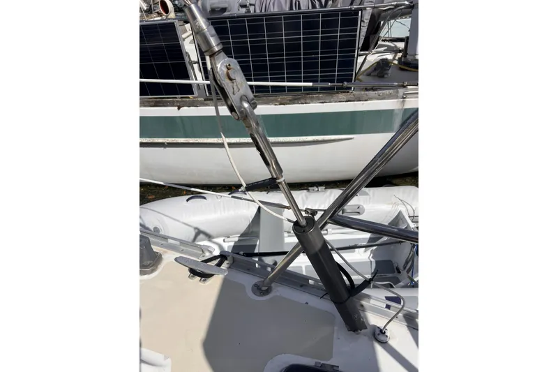 Slide: The Image of Close-up of a 1991 Perry 51 sailboat rigging with solar panels in the background. - 48