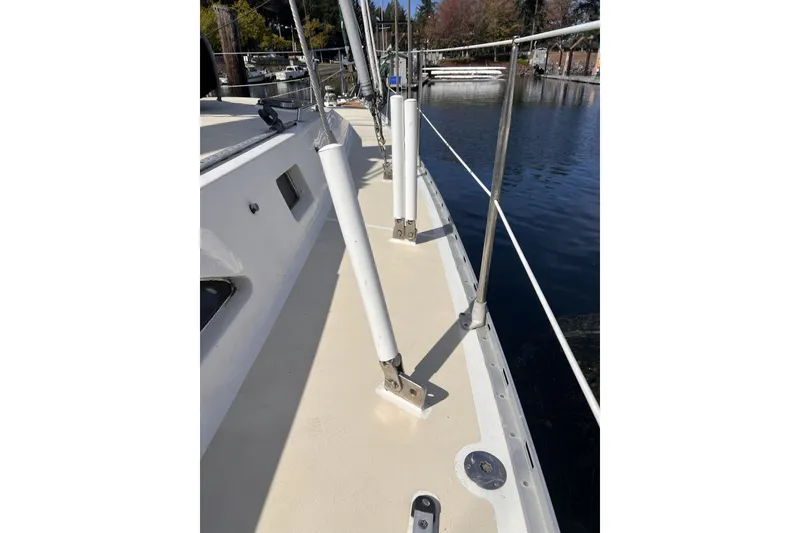 Slide: The Image of Deck view of 1991 Perry 51 sailboat with railing and water background. - 49