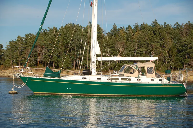 The Image of Sailboat Perry 51, 1991 model, anchored in serene waters with forested background. - 0