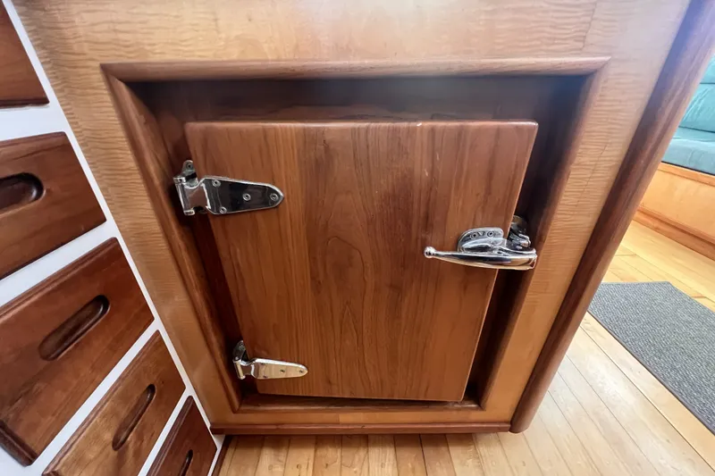 Slide: The Image of Wooden cabinet with metal latch on a 1991 Perry 51 boat interior. - 58