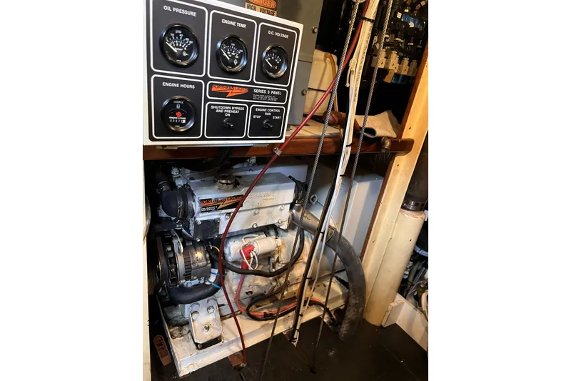Slide: The Image of Engine room of a 1991 Perry 51 with control panel and wiring. - 106