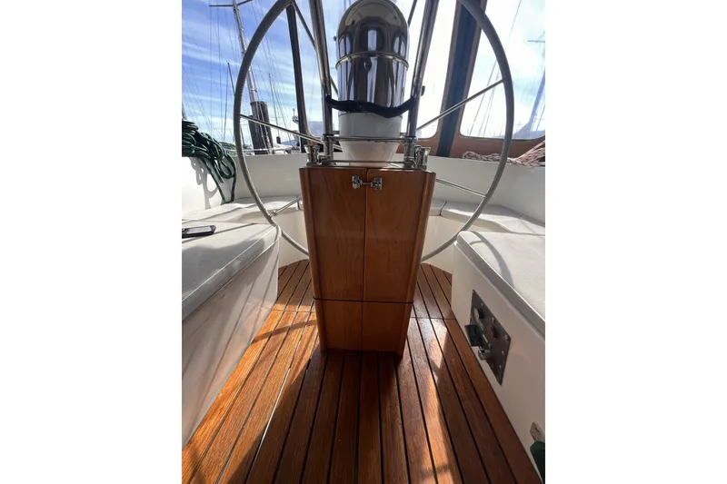 Slide: The Image of Cockpit of 1991 Perry 51 sailboat with wooden flooring and steering wheel. - 45